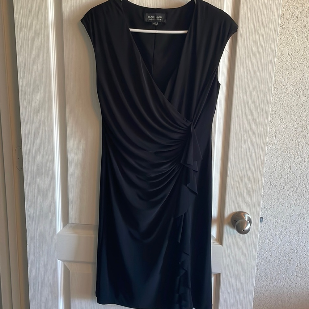 Women’s size 12 black dress. 95% polyester. Good condition.